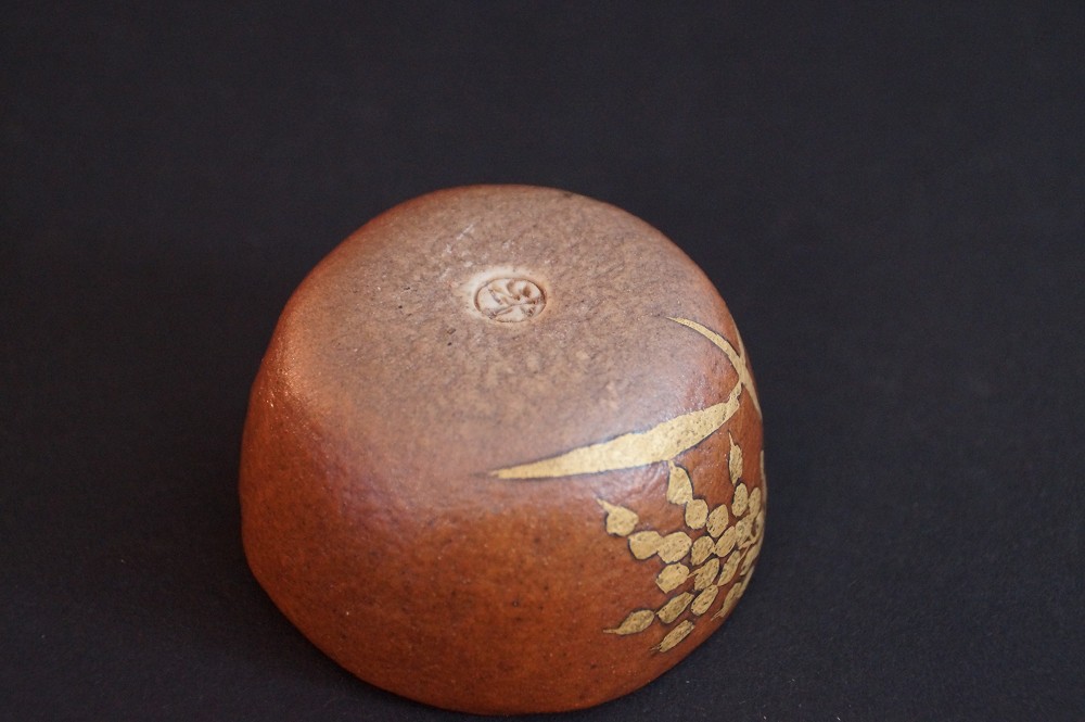 Close-up of the bright interior, the cup lying on orange cloth with red seal