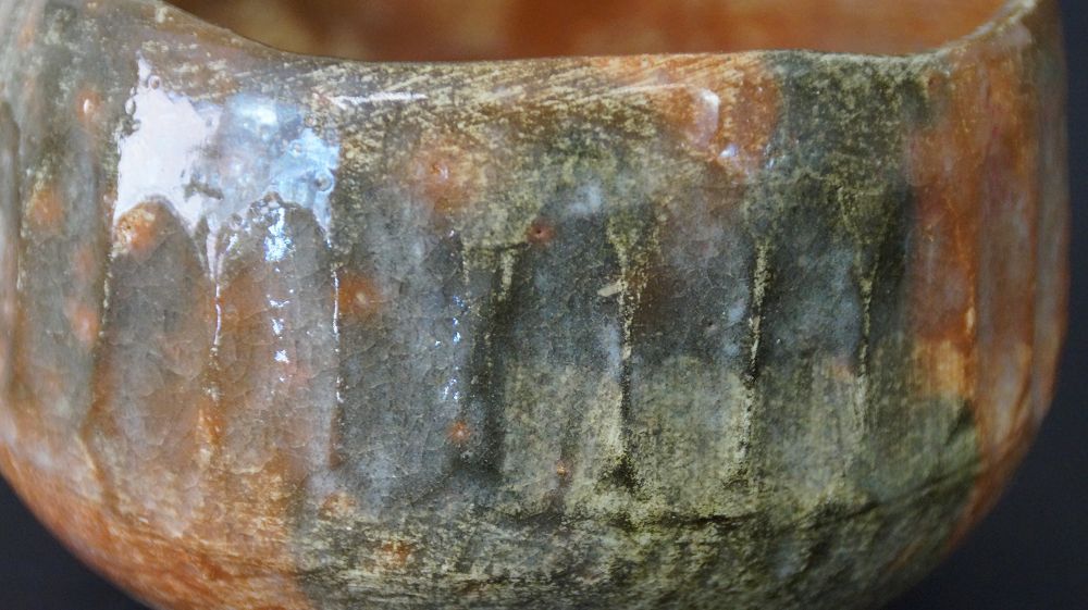 Extreme close-up of the flowing glaze structure of the chawan tea bowl made of Raku ware