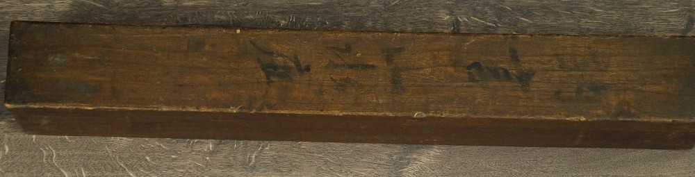 Close-up of the plain storage box with hand-written title inscription