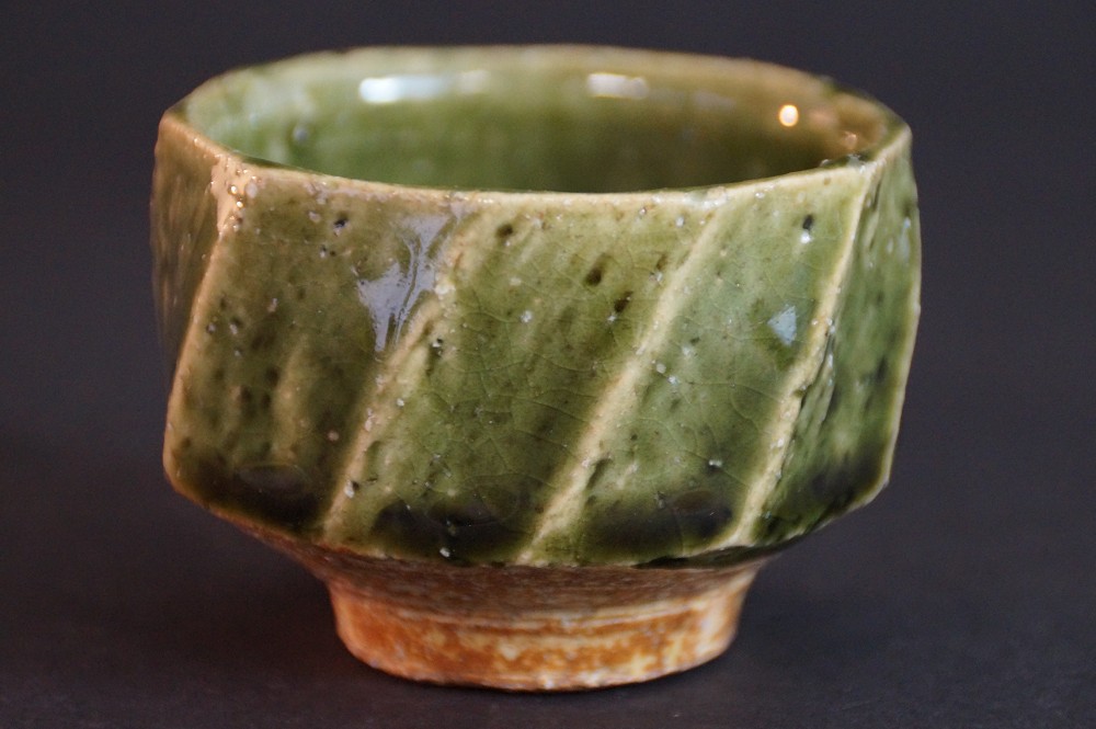 Additional side view with diagonal copper-green glaze bands on the faceted walls
