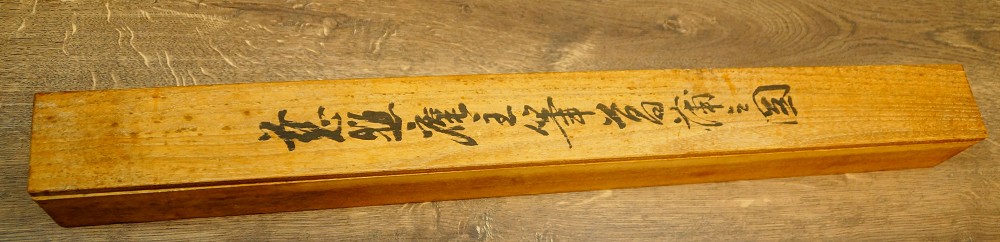 Close-up of the ink inscription on the lid of the storage box