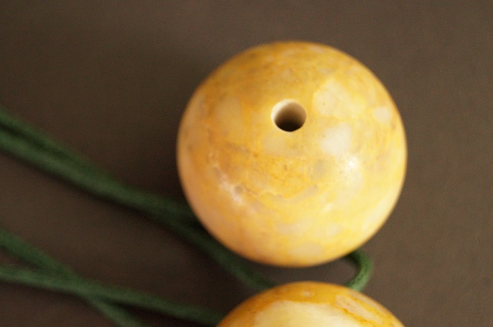 Yellow Marbled Stone Sphere with Drill Hole in Close-Up Stone Close-Up 2