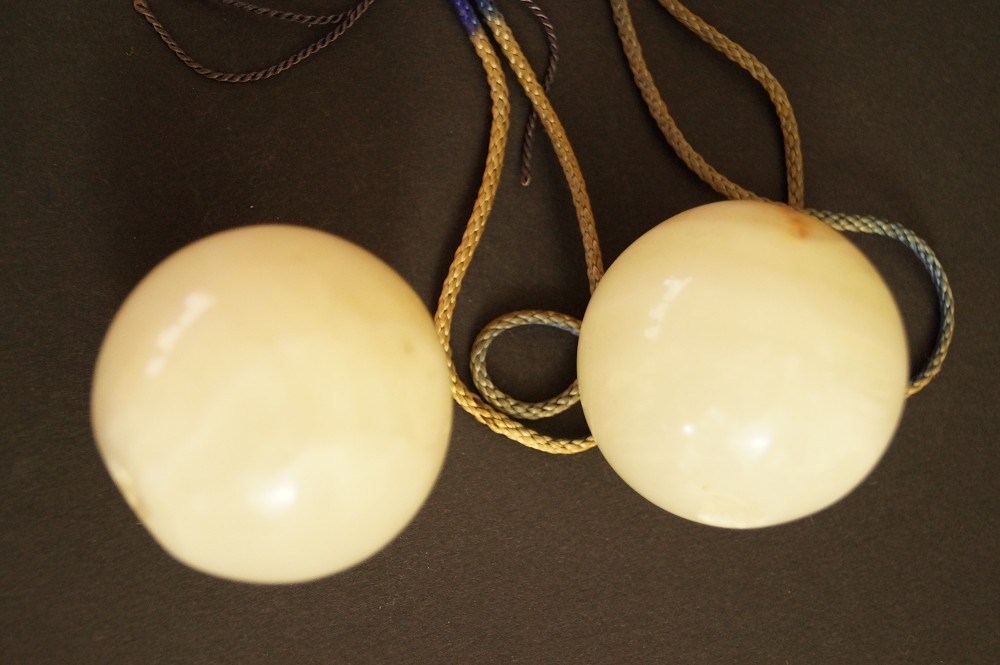 Two Light-Colored Natural Stone Spheres with Cords Side by Side Stone Close-Up 3