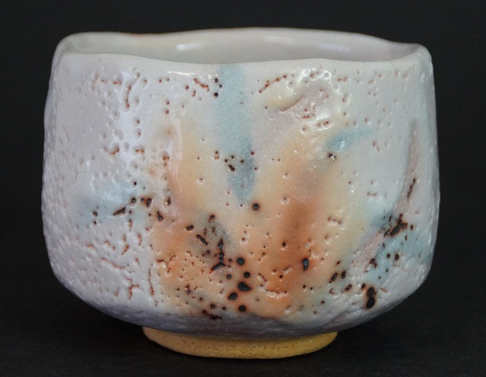 Additional view of the chawan made of Shino ware with pastel-colored glaze in pink, blue, and orange