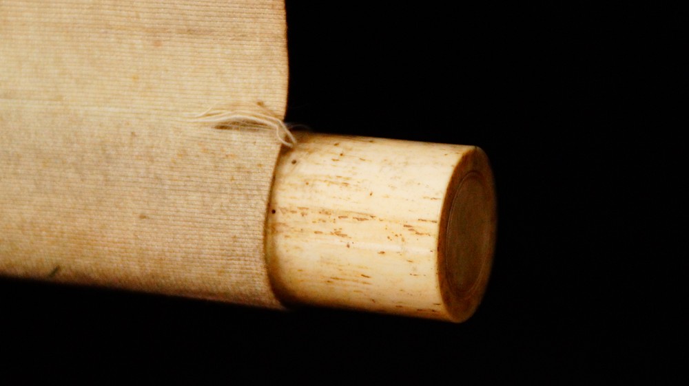 Close-up of the ivory-colored roller end of the kakemono