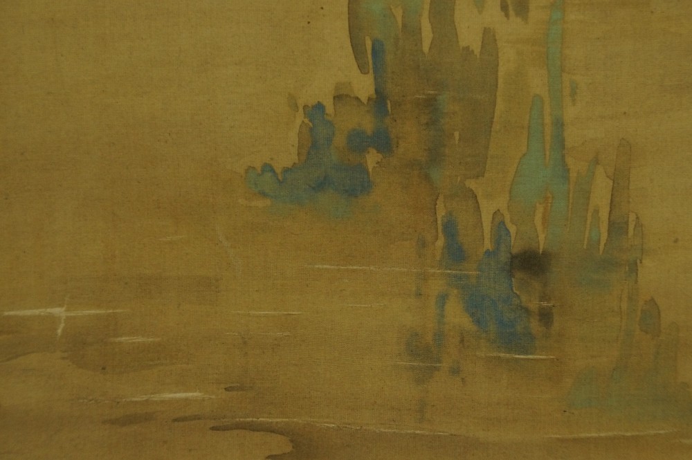 Close-up of the blue-green reed and water suggestions at the base of the rock