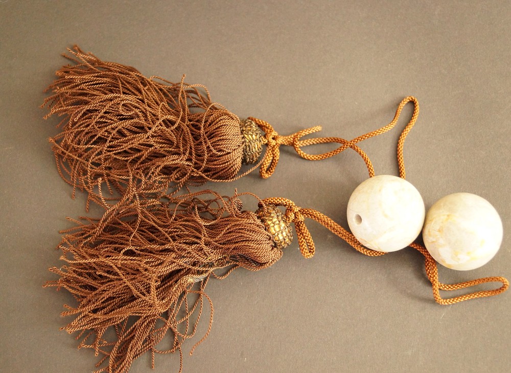 Two fuchin ornamental weights with brown tassels and cords set front view 1