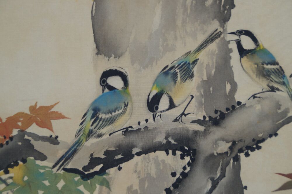 Close-up of three birds feeding on a branch in the hanging scroll Birds in Autumn Maple