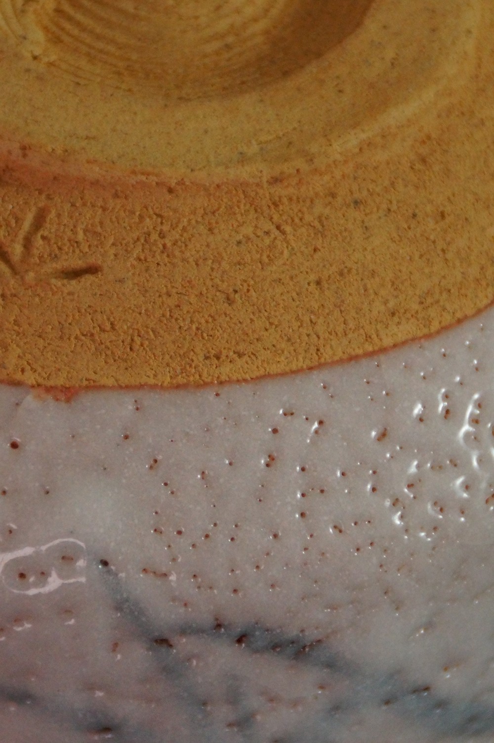 Further close-up of the unglazed base with incised artist's mark