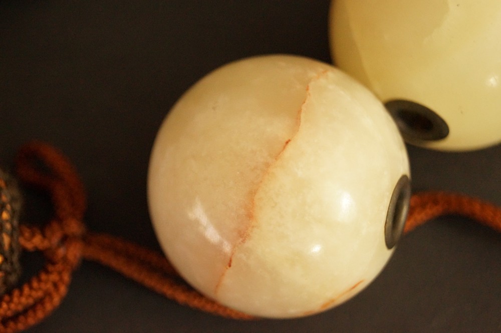 Natural stone sphere with reddish-brown vein in close-up Stone Close-Up 2