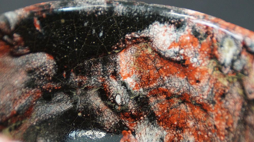 Extreme Close-Up of the Red-Black-White Glaze Structure of the Chawan Tea Bowl Made of Raku Ware