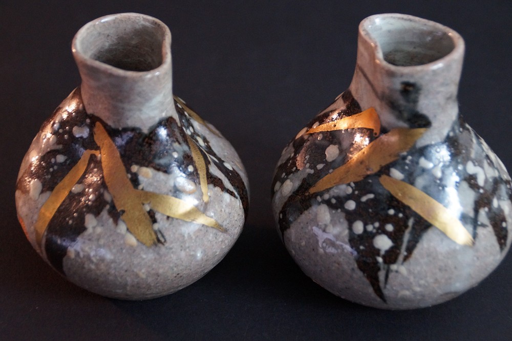 Additional side view with dark speckled glaze and gold brushstrokes