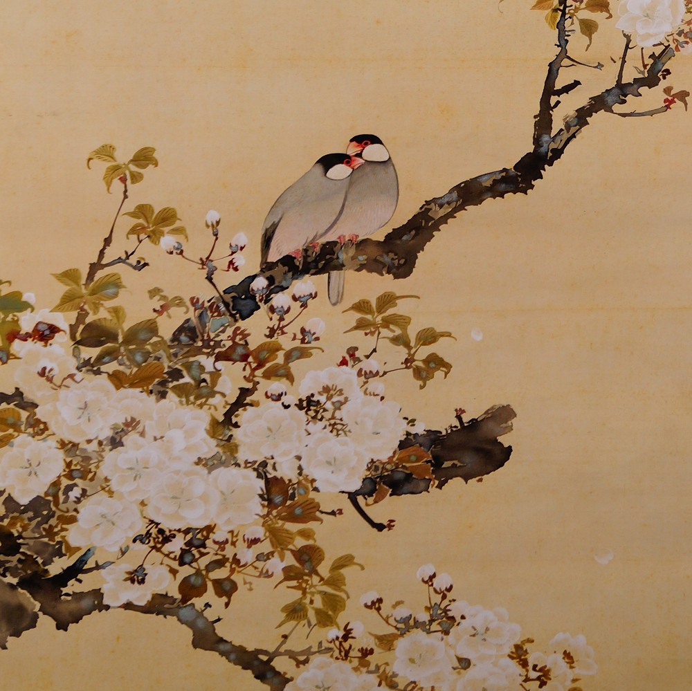 Two closely nestled birds on a blooming cherry branch in the hanging scroll Spring Awakening