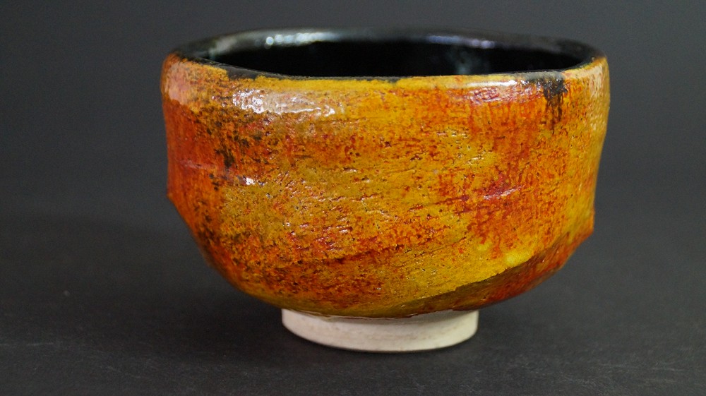 Further side view of the chawan made of Tobe ware with iridescent amber glaze by Haryoku