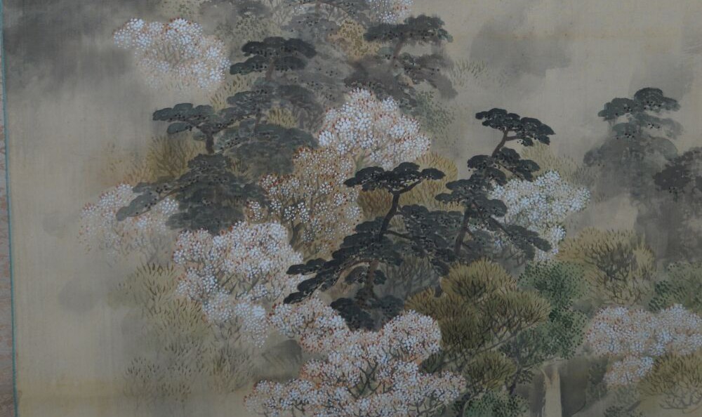Kakemono by Hata Getsushū: raftsman on a river between blossoming trees and mountains.