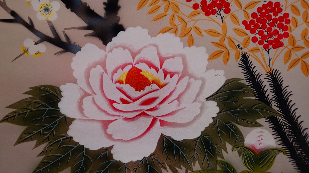Close-up of the pink peony with nandina berries in the background