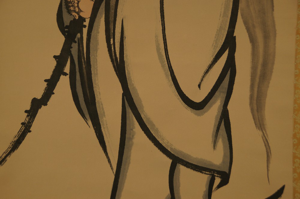 Close-up of the powerful brushwork in the robe with staff