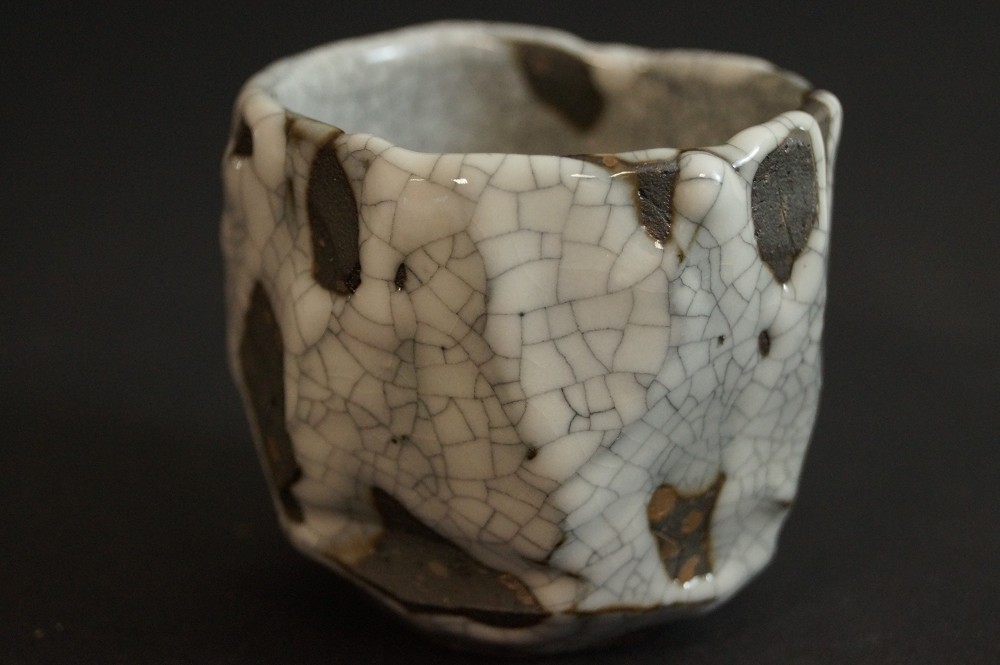 Shino sake cup with crackled white glaze and dark spots side view 1