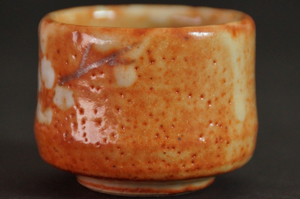 Further side view of the guinomi with partial plum blossom motif