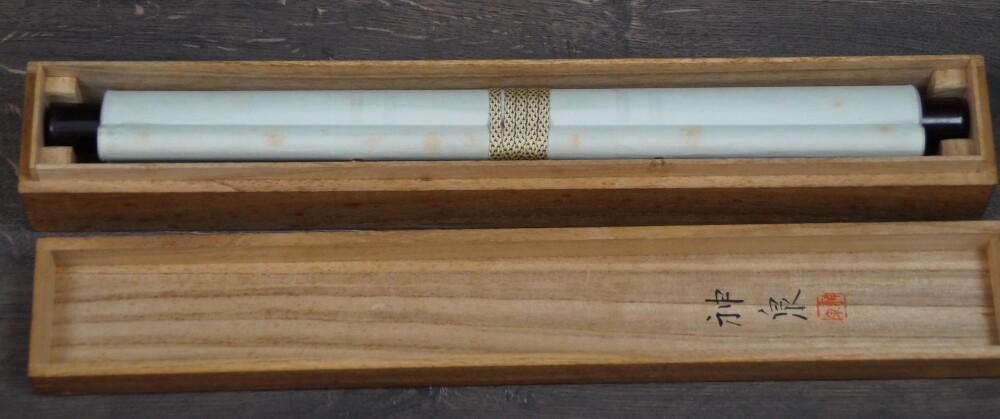Rolled Hanging Scroll Plum Blossoms in Quiet Early Light with Ivory-Colored Roller Ends in the Opened Storage Box with Ink Inscription on the Lid