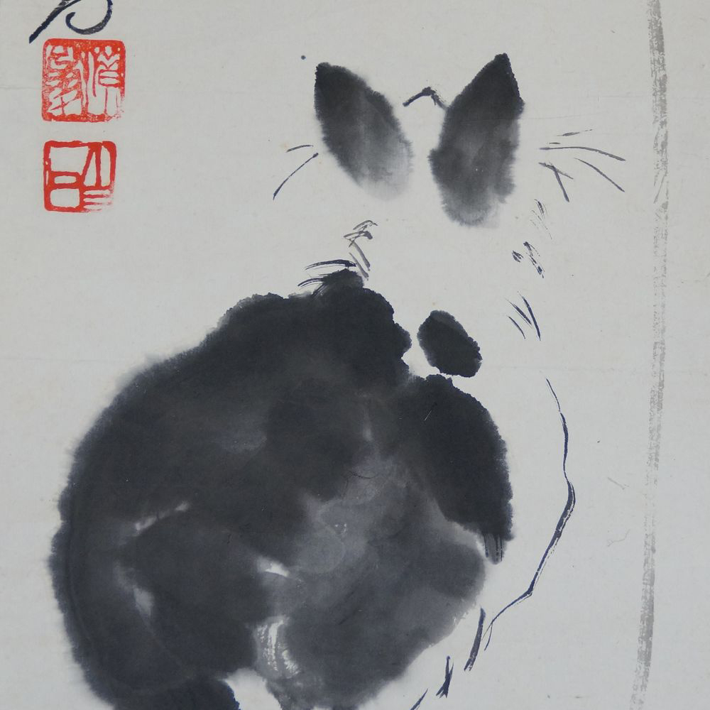 Detail view of the artist's signature and the two red seals next to the black cat's ears