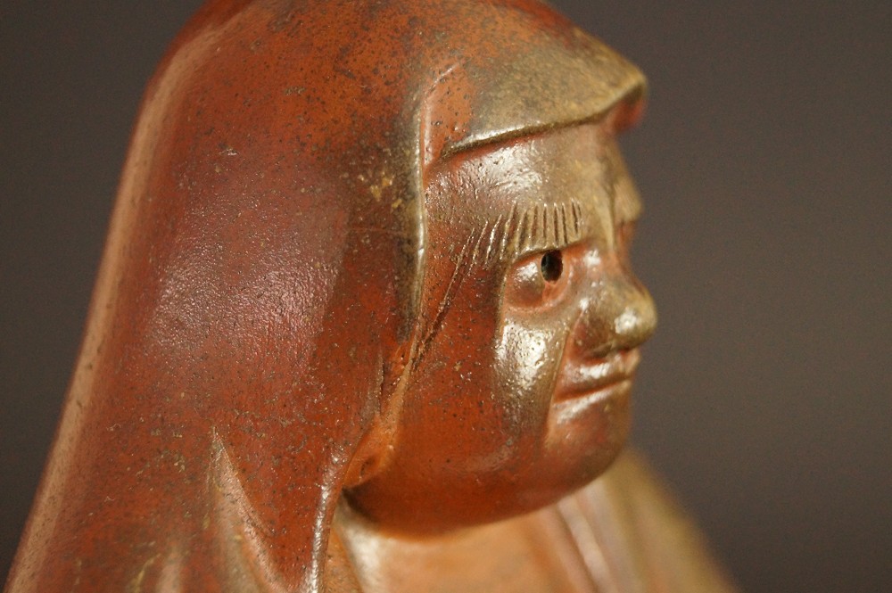 Bodhidharma Daruma figure made of Bizen ware motif close-up 3 face profile