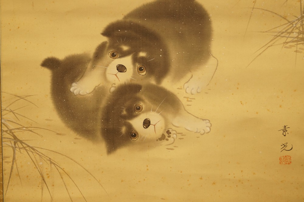 Two puppies in the snow signature and seal close-up