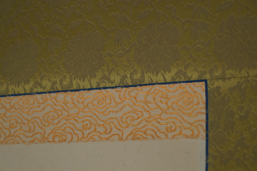 Gold silk brocade and mat corner mounting detail