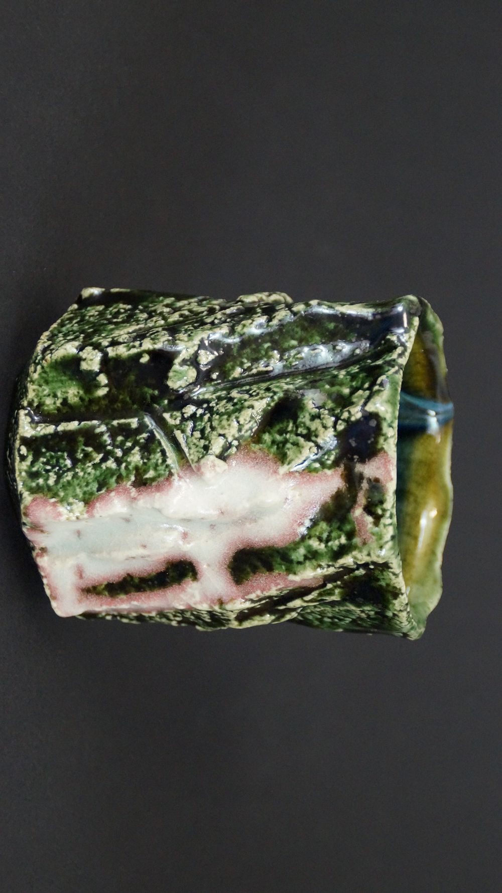 Additional view of the Yunomi tea bowl made of Oribe ware with green textured glaze and pink accent