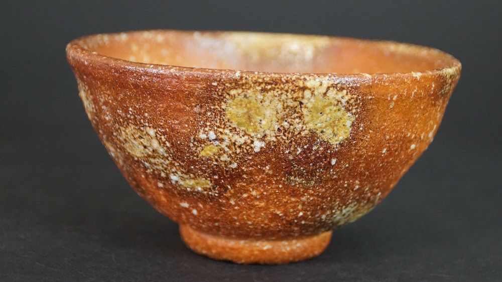 Further view of the chawan made of Shigaraki ware with reddish-brown fire skin and light feldspar inclusions
