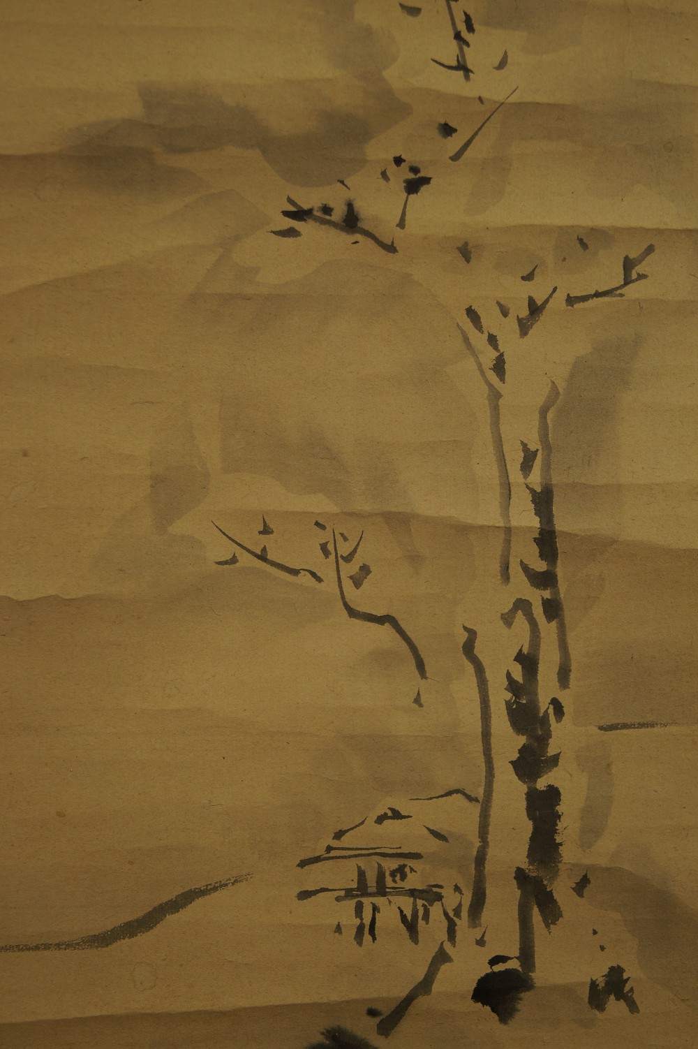 Bare tree with hut motif close-up