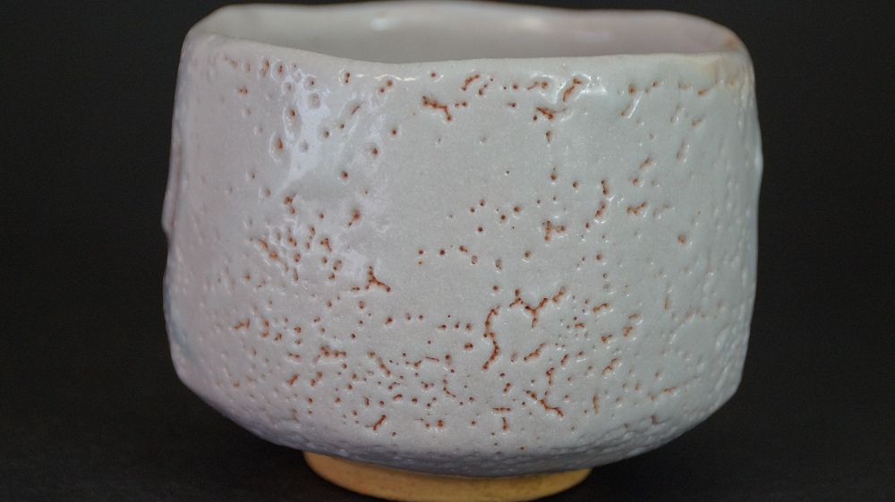 Another view of the chawan made of Shino ware from the side with finely speckled glaze