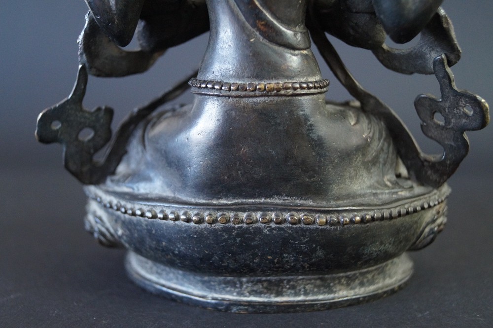 Nepalese Buddha figure made of bronze base close-up 1