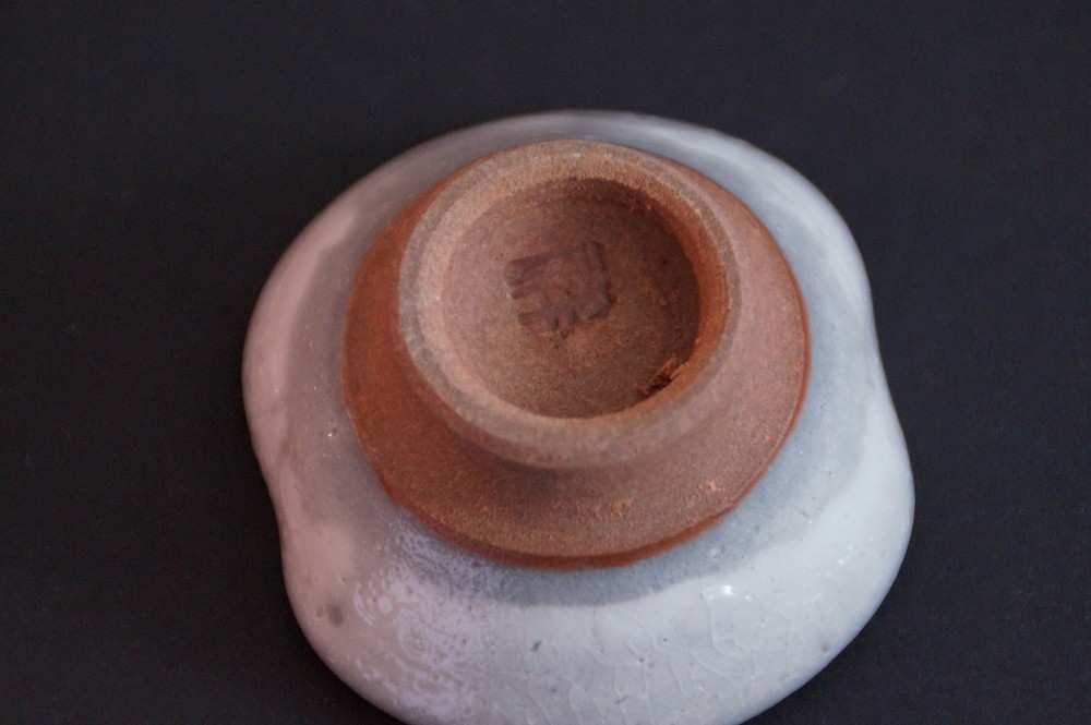 Close-up of the stamped potter's mark on the base