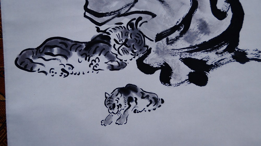 Close-up of the reclining tiger and the small tiger cub in ink painting