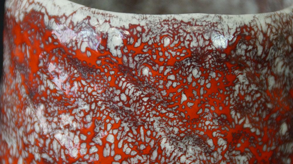 Extreme close-up of the net-like crackled red and white glaze structure of the Chawan tea bowl made of Minoh ware