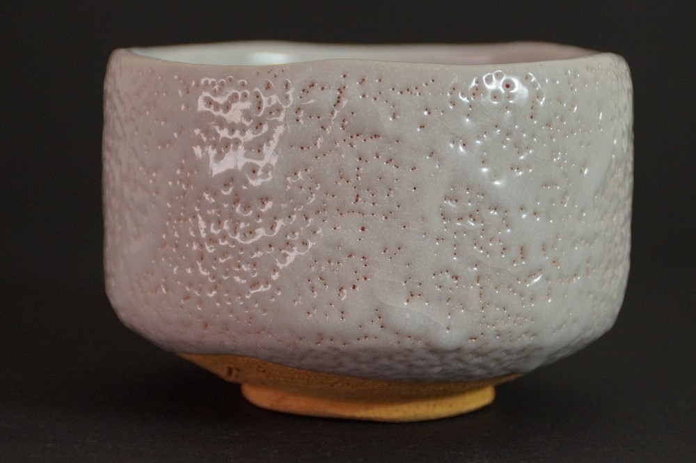 Side view of the chawan with creamy white Shino glaze and blue color shadows