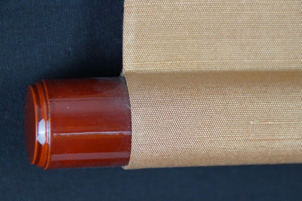 Detailed view of the scroll end with amber-colored knob and cream-colored silk of the Kakemono Calligraphy Snow