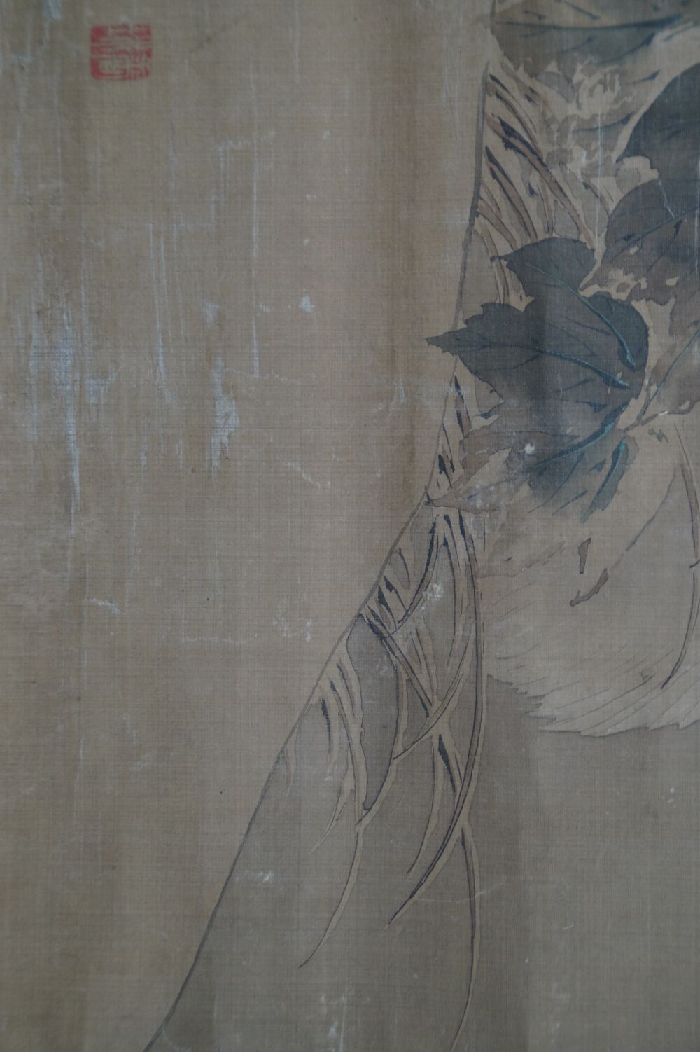 Detail view of heron plumage and foliage with red seal in the Kakemono Heron in Quiet Peony Splendor
