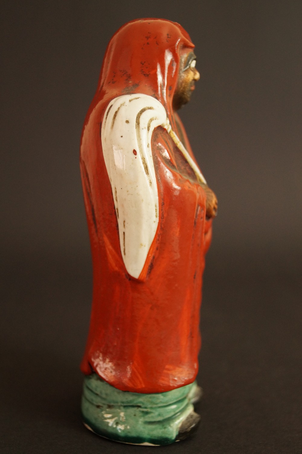 Bodhidharma Daruma Figure Made of Red Kutani Porcelain Side View of the Figure with Red Hood Side View