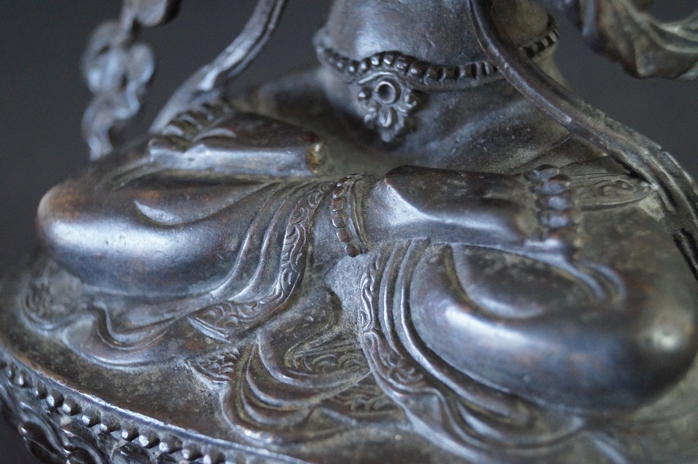 Nepalese Buddha figure in bronze motif close-up 4