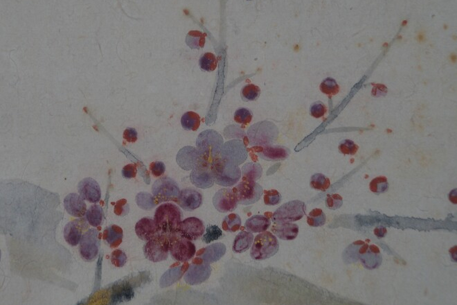 Hand-painted plum blossom branch on a Japanese hanging scroll, pink and purple blossoms with red buds on light washi paper
