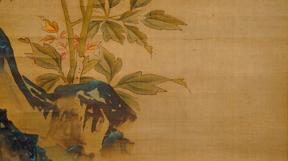 Close-up of the blue-gray rock with a small orange blossom branch
