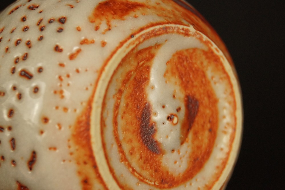 Base of the sake bottle from below foot close-up