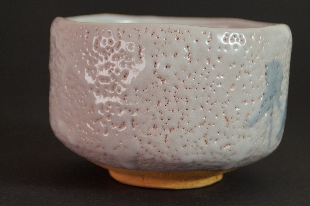 Further side view of the chawan with an organically shaped rim and Shino glaze