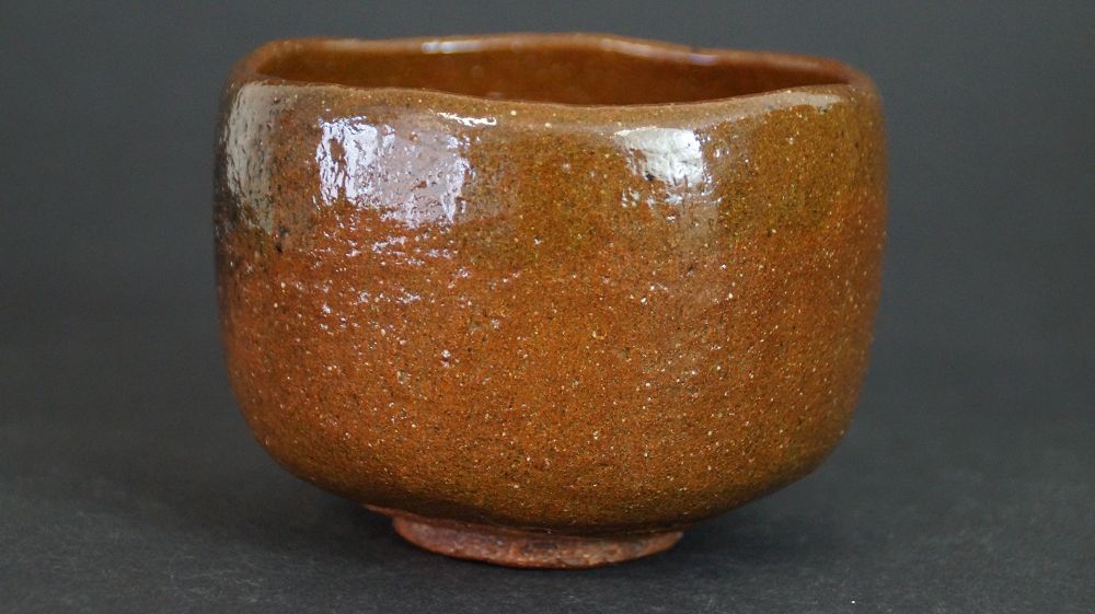 Additional view of the chawan made of Ohi ware with even honey-brown glaze
