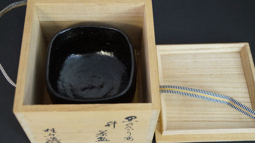 Chawan made of Raku ware in the opened storage box next to the inscribed box lid
