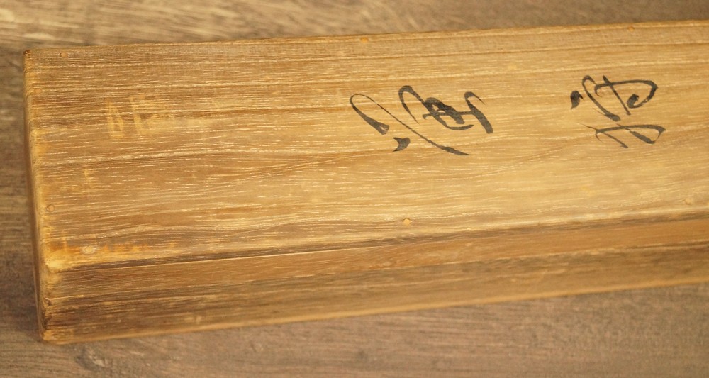 Wooden lid of the storage box with ink signature and red seal Storage Box Close-Up