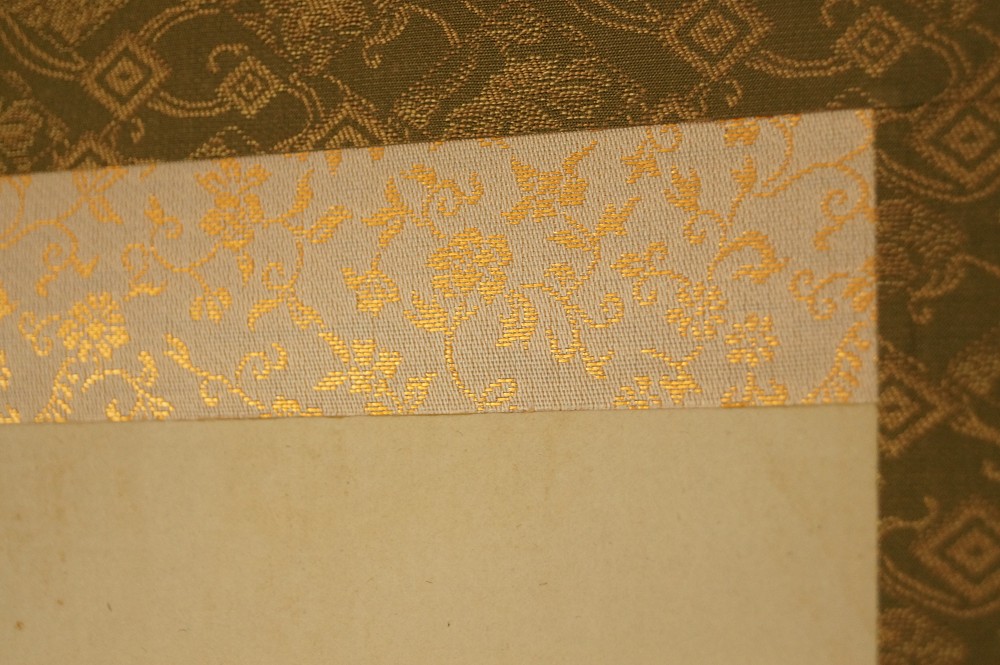 Olive-green brocade mounting with cream-colored floral band mounting detail