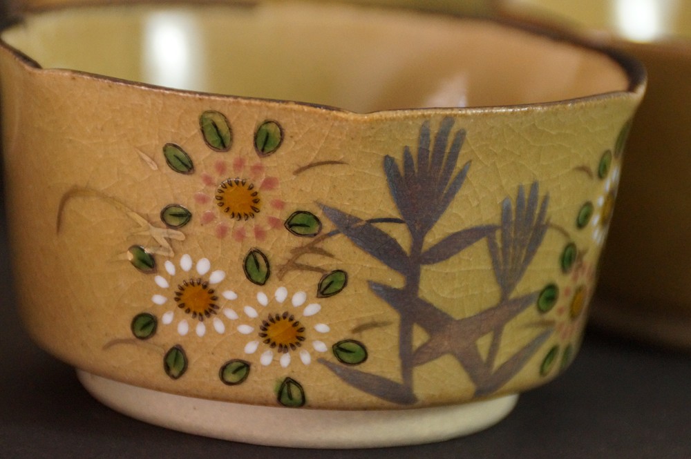 Close-up of the hand-painted chrysanthemum and bamboo motif on a bowl